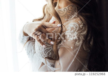 A tender bride strokes her body with her hands and sensually touches her skin. Sensual moment A tender bride strokes her body with her hands and sensually touches her skin. Sensual moment 119252968