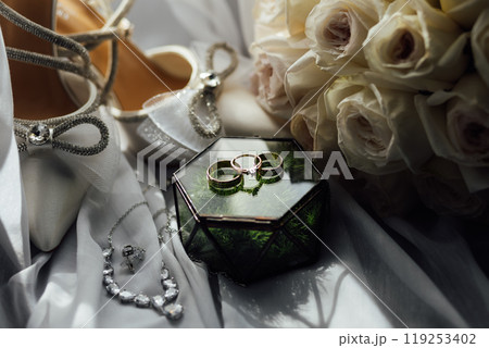 The bride's wedding accessory in the form of a bouquet, wedding gold rings and shoes. 119253402