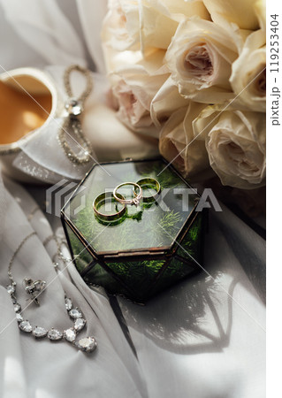 The bride's wedding accessory in the form of a bouquet, wedding gold rings and shoes. The bride's wedding accessory in the form of a bouquet, wedding gold rings and shoes. 119253404