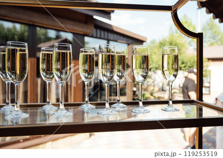 Glasses of champagne at the Banquet, white sparkling wine in wine glasses, festive mood Glasses of champagne at the Banquet, white sparkling wine in wine glasses, festive mood 119253519