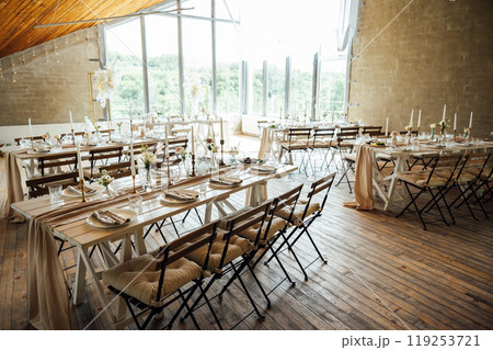 Elegant neutral coloured wedding table scape with flowers and candles Elegant neutral coloured wedding table scape with flowers and candles 119253721