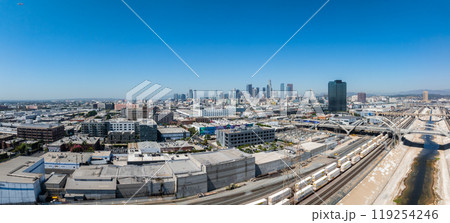 Panoramic aerial view of downtown Los Angeles with skyline in the distance. The Los Angeles River and train tracks highlight the urban landscape. Panoramic aerial view of downtown Los Angeles with skyline in the distance. The Los Angeles River and train tracks highlight the urban landscape. 119254246