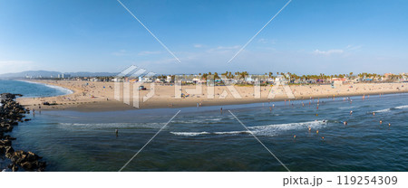 Panoramic aerial view of Venice Beach in Los Angeles, California, featuring sandy shores, Pacific Ocean waves, palm trees, and beachfront buildings. Panoramic aerial view of Venice Beach in Los Angeles, California, featuring sandy shores, Pacific Ocean waves, palm trees, and beachfront buildings. 119254309