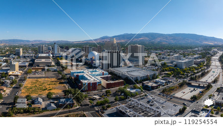 Aerial view of Reno, Nevada, featuring high rise buildings, casinos, and the National Bowling Stadium. Sierra Nevada mountains form the backdrop. 119254554