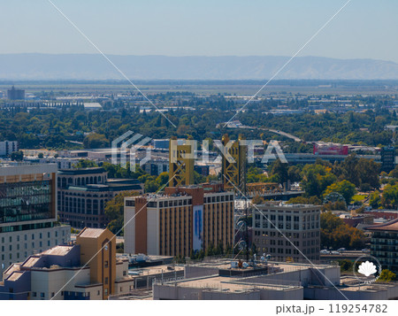 Aerial view of Sacramento highlighting the yellow gold Tower Bridge, surrounded by modern and historic buildings, greenery, and distant mountains. Aerial view of Sacramento highlighting the yellow gold Tower Bridge, surrounded by modern and historic buildings, greenery, and distant mountains. 119254782