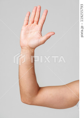 A person hand gesture against a neutral background 119255793