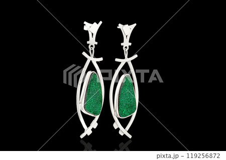 Beautiful gold, silver earrings with Uvarovite stone on a black background Beautiful gold, silver earrings with Uvarovite stone on a black background 119256872