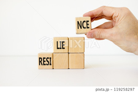 Resilience symbol. Concept word Resilience on beautiful wooden cubes. Businessman hand. Beautiful white background. Business resilience concept. Copy space. 119258297