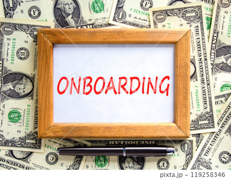 Onboarding success symbol. Concept word Onboarding on beautiful wooden picture frame. Beautiful dollar bills background. Dollar bills. Black pen. Business onboarding success concept. Copy space. Onboarding success symbol. Concept word Onboarding on beautiful wooden picture frame. Beautiful dollar bills background. Dollar bills. Black pen. Business onboarding success concept. Copy space. 119258346