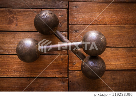 Old rusty dumbbells on wood background texture 119258396