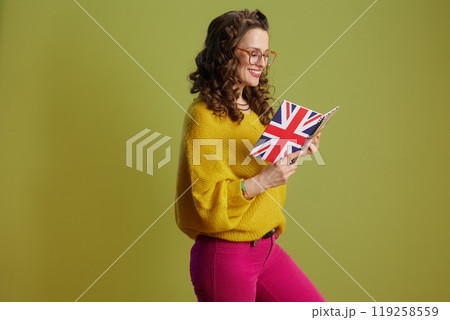 happy trendy female in sweater and glasses isolated on green 119258559