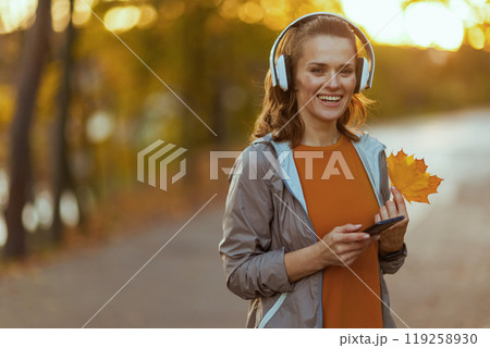 Portrait of happy trendy female in fitness clothes in park Portrait of happy trendy female in fitness clothes in park 119258930