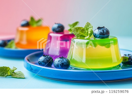 Colorful jelly dessert delight with blueberries and mint on vibrant plates. 119259076