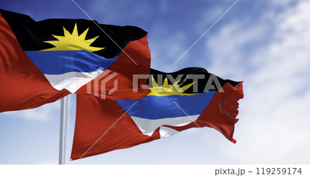 Two Antigua and Barbuda national flags waving on a clear day Two Antigua and Barbuda national flags waving on a clear day 119259174