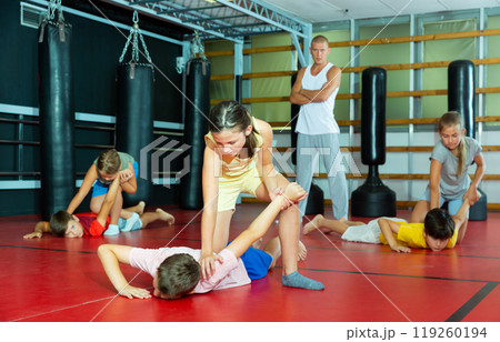 Kids in pair exercising self-defense movements Kids in pair exercising self-defense movements 119260194