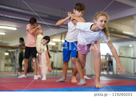 Teenager kids exercising self-defense movements 119260201