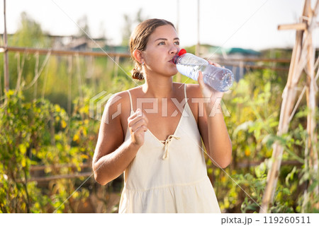 Young woman posing with bottle of water Young woman posing with bottle of water 119260511