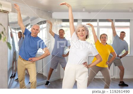 Group of aged people rehearsing sports dance in dance class Group of aged people rehearsing sports dance in dance class 119261490