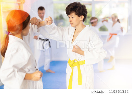 Boy and girl training karate techniques in studio Boy and girl training karate techniques in studio 119261532