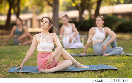 Yoga lesson visitors girls perform lord of fishes in park 119261572