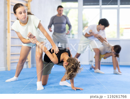 Boy and girl practicing self-defense techniques Boy and girl practicing self-defense techniques 119261766