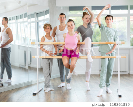 Portrait of group of teenagers together with choreography teacher during break between ballet lessons 119261859