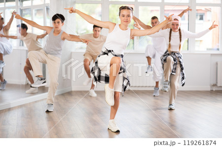 Teenage girl dancing hip hop in group 119261874