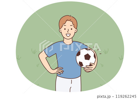 A young smiling boy stands holding a soccer ball 119262245