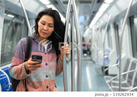 Woman passenger using phone in subway car 119262934