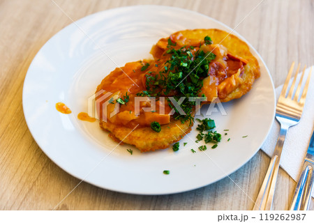 Belarusian draniki with vegetable and sausage stew Belarusian draniki with vegetable and sausage stew 119262987