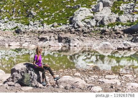 Female Mountain Traveler Resting During Hiking 119263768