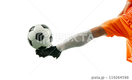 Close-up shot of football player's leg striking ball, perfectly timed for powerful kick against white studio background. Close-up shot of football player's leg striking ball, perfectly timed for powerful kick against white studio background. 119264598