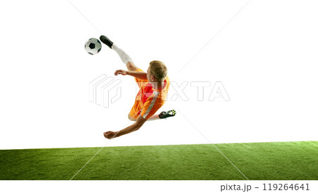Football player in mid-motion demonstrates dynamic jump kick, creating striking scene that captures intensity of game. 119264641