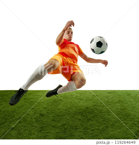 Focused soccer player executing perfect high kick, showing agility and determination in pursuit of victory. Dynamic photo. 119264649