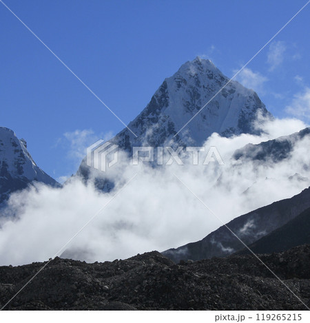 High mountain Cholatse surrounded by autumn fog. View from Gorakshep, Nepal. 119265215