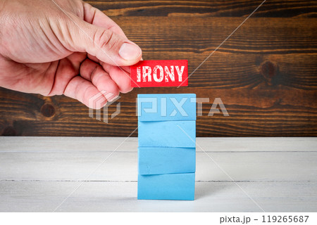Irony Concept. Blue wooden blocks in a pile on a white wooden table 119265687