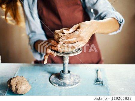 Female artist sculpts crafts with ceramic clay at her creative workshop 119265922