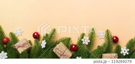 Christmas decorations and fir tree branch and gift boxon dark table. Top view frame with copy space Christmas decorations and fir tree branch and gift boxon dark table. Top view frame with copy space 119269279