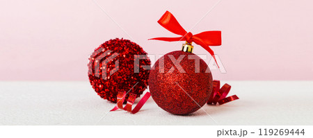 Christmas ball on colored background. decoration bauble with ribbon bow with copy space 119269444