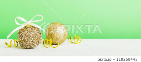 Christmas ball on colored background. decoration bauble with ribbon bow with copy space Christmas ball on colored background. decoration bauble with ribbon bow with copy space 119269445