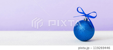 Christmas ball on colored background. decoration bauble with ribbon bow with copy space Christmas ball on colored background. decoration bauble with ribbon bow with copy space 119269446