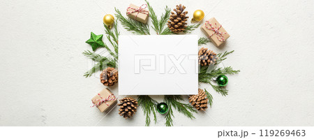 Flat lay Christmas composition. square Paper blank, pine tree branches, christmas decorations on Colored background. Top view, copy space for text 119269463