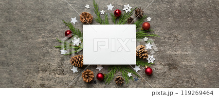 Flat lay Christmas composition. square Paper blank, pine tree branches, christmas decorations on Colored background. Top view, copy space for text Flat lay Christmas composition. square Paper blank, pine tree branches, christmas decorations on Colored background. Top view, copy space for text 119269464