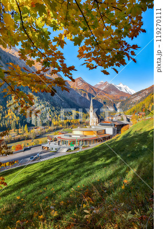 Amazing autumn landscape  at Heiligenblut with St Vincent Church near Grossglockner mount . 119270111