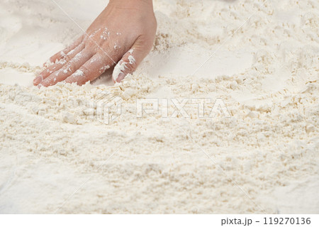 Baker working with white wheat flour, hands close-up. Baker working with white wheat flour, hands close-up. 119270136