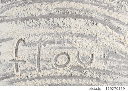 Text flour written on white wheat flour top view. 119270139