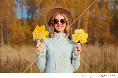 Autumn portrait of stylish happy young woman with yellow leaves, girl smiling outdoors in park Autumn portrait of stylish happy young woman with yellow leaves, girl smiling outdoors in park 119271777