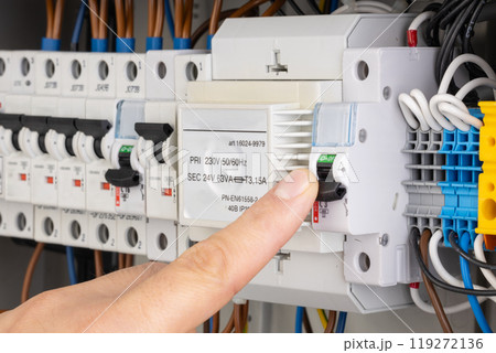 Finger Switching Off Circuit Breaker in Electrical Panel Finger Switching Off Circuit Breaker in Electrical Panel 119272136