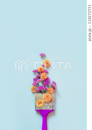Autumn creative concept of yellow and pink autumn flowers and paint brush on blue background. Fashion minimal art. View from above. 119272551
