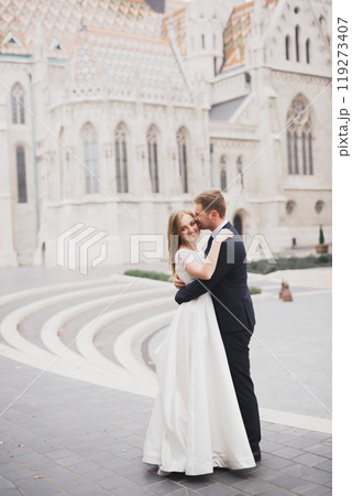 Wedding couple holding hands, groom and bride together on wedding day Wedding couple holding hands, groom and bride together on wedding day 119273407